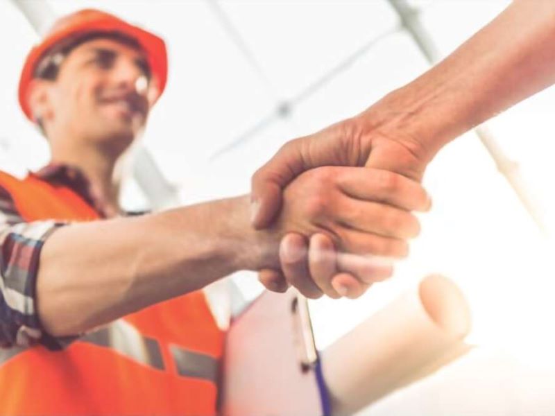 worker holding hands with the man